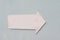 pink elongated arrow on rough bluish background for graphic