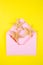 Pink envelope with three starfishes on colored yellow background