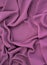 Pink fabric texture. wavy textile rippled from top point of view