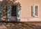 Pink facade and blue window and doors, typical French architecture house. France