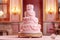 Pink festive four-tier cake against the backdrop of the banquet hall close-up.