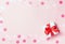Pink festive holiday background with goft box and pink confetti.
