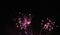 Pink fireworks against the dark midnight black sky