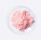 Pink flake chemicals in Chemical Watch Glass Top View. Closeup Ornamental Plant Fertilizer