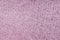 Pink fleecy synthetic fabric textile background. Soft plush fluffy cloth texture