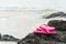 Pink flip flop on the rock for summer holiday