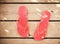 Pink flip flop sandals on wood