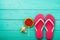 Pink flip flops with watermelon candy food and copy space on blue wooden background. Top view. Mock up. Copy space. Summer time