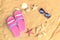 Pink flip fops, sunglasses, starfishes and seashells