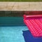 Pink float in swimming pool.