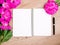 Pink floral assorted pink flower on wooden background with notepad free space, copy space for tekst