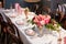 Pink flower design on the served restaurant table for Sunday girly brunch party