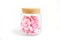 Pink flower inside glass bottle isolate on white with work path