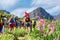 Pink flowers against hiking group