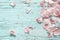 Pink flowers petal on pastel wooden flat lay, top view
