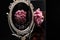 A pink flowers reflection in a Vintage Oval Desk Mirror with white frame on black background