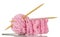 Pink fluffy ball of yarn, wooden knitting needles and pin for handicraft isolated on white