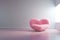 Pink fluffy huge sofa in the shape of a chubby heart.