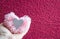 Pink fluffy pompom of thread-shaped hearts with a silver insert in the palm