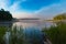 Pink fog over the morning river. Fresh morning in sunny weather. Fishing spot