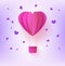 Pink folded paper hot air balloon in form of heart surrounded by little heart shapes on pastel violet background.