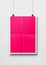 Pink folded poster hanging on a white wall with clips