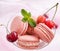 Pink french macarons with cherry