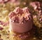 pink frosted cake sitting on gold background