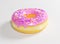 Pink  frosted donut with colorful sprinkles. 3D Illustration.