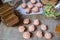 Pink frosted vanilla and chocolate cupcakes sit on a table cloth of burlap with other candies