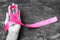 Pink fuchsia ribbon on woman`s hand isolated with clipping path for raising Breast cancer awareness and women`s health campaign