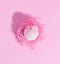 Pink furry egg in a paper nest. Creative concept.