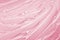Pink gel texture. Cosmetic clear liquid cream smudge. Transparent skin care product sample closeup