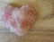 Pink gemstone heart on wood background