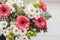 Pink gerbera,white daisy and green chrysanthemum in beautiful br