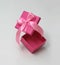 Pink gift box with satin ribbon. Open in motion. Space for goods and text. Unboxing process. Sale coupon template.