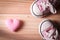 Pink girl`s sneakers with pink hearts on a wooden floor