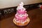 Pink girlish birthday cake with number four candle