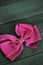 Pink girls hair bow on a wooden background
