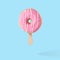 Pink glazed donut with ice cream stick on blue pastel background