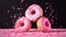 Pink glazed donuts in motion. High resolution.