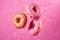 Pink glazed donuts in motion. High resolution.