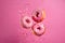 Pink glazed donuts in motion. High resolution.