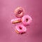 Pink glazed donuts in motion. High resolution.