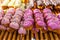 Pink glazed vanilla donut skewer for sale at bakery