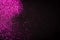 Pink glitter on black backgrund with copy space