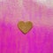 Pink glittering background with golden heart. Romantic design