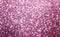 Pink glittery bright shimmering background use as a design backdrop.
