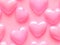 Pink glossy heart shapes seamless background for valentines day, love pattern.