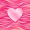 Pink glossy heart on silky background